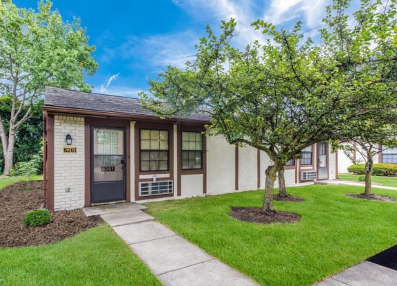 a small building with a sidewalk and trees in front of it at Parkside at Maple Canyon Apartments, Columbus, OH 43229