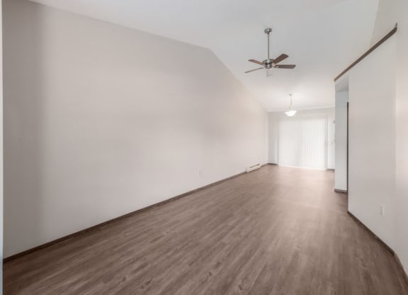 a room with white walls and wood floors and a ceiling fan at Parkside at Maple Canyon Apartments, Ohio, 43229