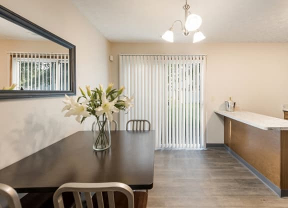 a dining room with a table and chairs and a kitchen  at Parkside at Maple Canyon Apartments, Ohio