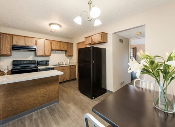 a kitchen and dining room with a black refrigerator at Parkside at Maple Canyon Apartments, Columbus, Ohio
