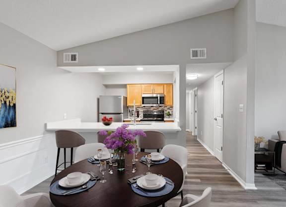 A modern dining room with a table set for two.