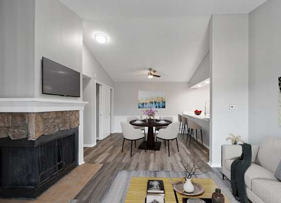 A modern living room with a fireplace and a television.