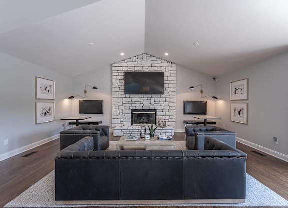 A living room with a fireplace and a large couch.