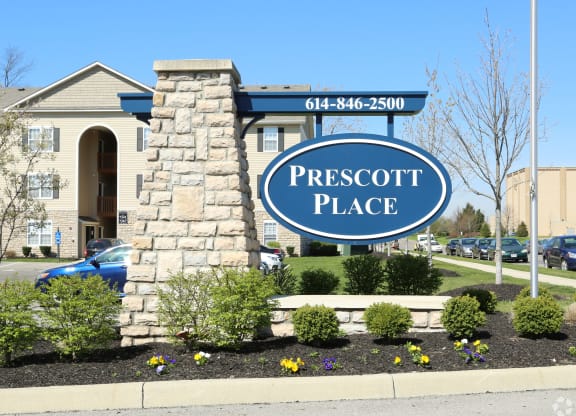 the place monument sign in front of the front yard of a building