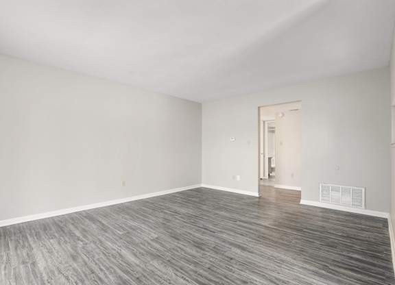 A room with a grey floor and white walls.