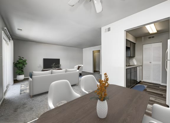 a living room with white furniture and a wooden table at Quail Run Apartments, Columbus