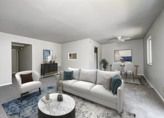 a living room with a white couch and a coffee table at Quail Run Apartments, Columbus, Indiana
