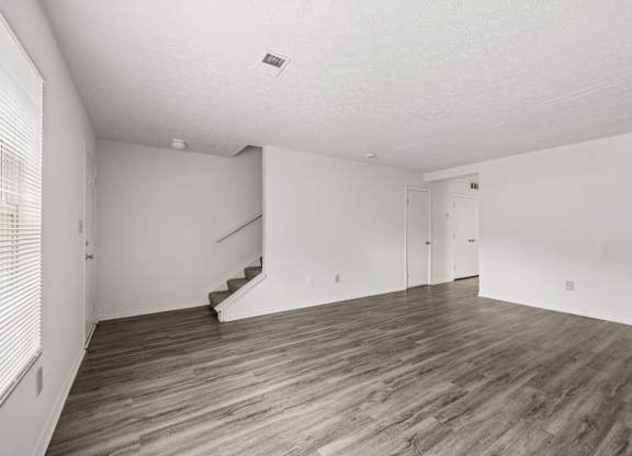 A room with wooden floors and white walls.