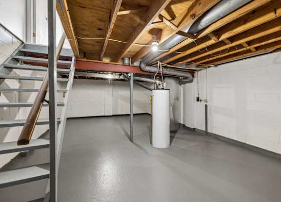 A room with a staircase and a white pillar. at Sharon Green Townhomes, Ohio
