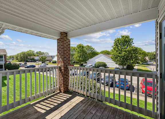 A white deck with a white railing and a white roof.