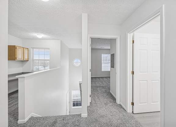 A white room with a desk and a window.