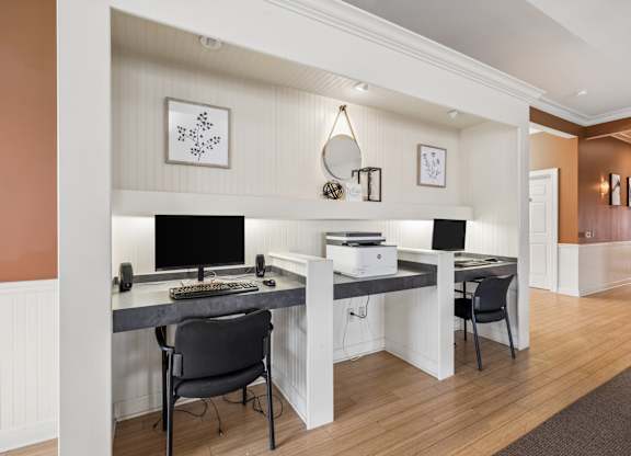 A home office with a desk, chair, and computer.
