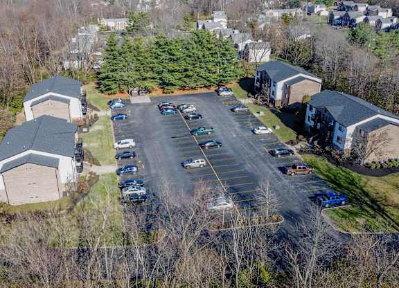 A parking lot with cars and a building in the background.