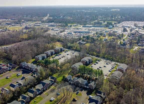 A bird's eye view of a residential area with houses and cars.