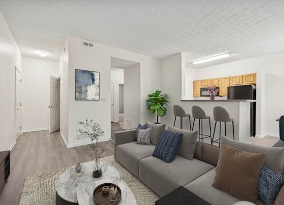 A living room with a grey couch and a coffee table.