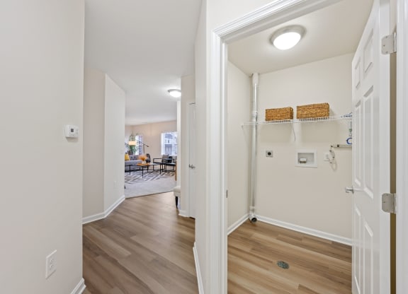 a hallway with hardwood floors and white walls at Roebling Row, Covington, Kentucky
