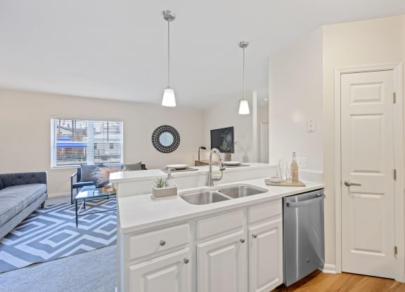 a kitchen with an island and a living room in the background at Roebling Row, Covington, 41011-1720