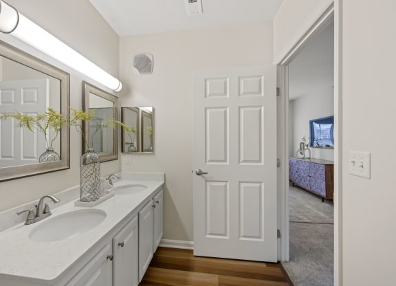a bathroom with two sinks and a mirror at Roebling Row, Covington, KY