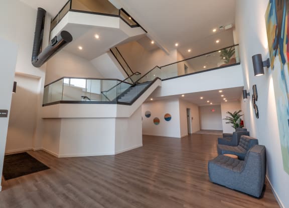 a large room with chairs and a staircase in a building at The Row on Merchant Apartments, Ohio