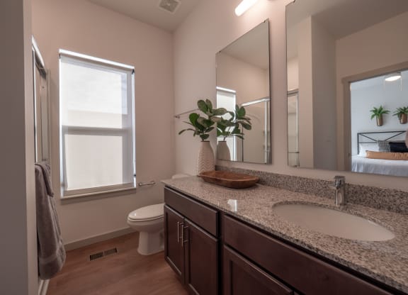 a bathroom with a sink and a toilet and a mirror at The Row on Merchant Apartments, Ohio, 45246