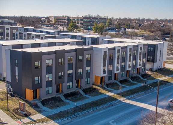an aerial view of an apartment complex with a road in front of it at The Row on Merchant Apartments, Springdale, OH
