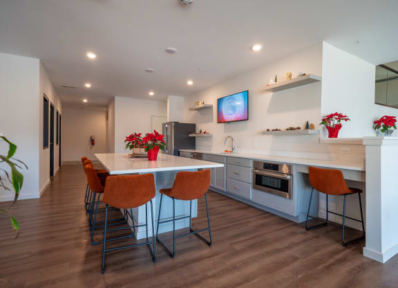 a kitchen and dining room with a table and chairs at The Row on Merchant Apartments, Ohio, 45246