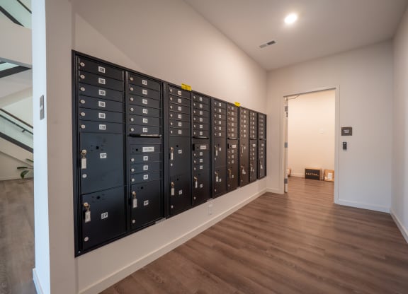 a lockers room in a room with wooden floors and a door to a room at The Row on Merchant Apartments, Springdale