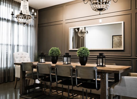 a dining room with a table and chairs and a mirror