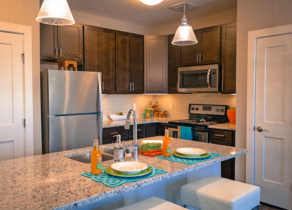 a kitchen with a granite counter top and stainless steel appliances at DeSales Flats Apartments*, Cincinnati, 45206