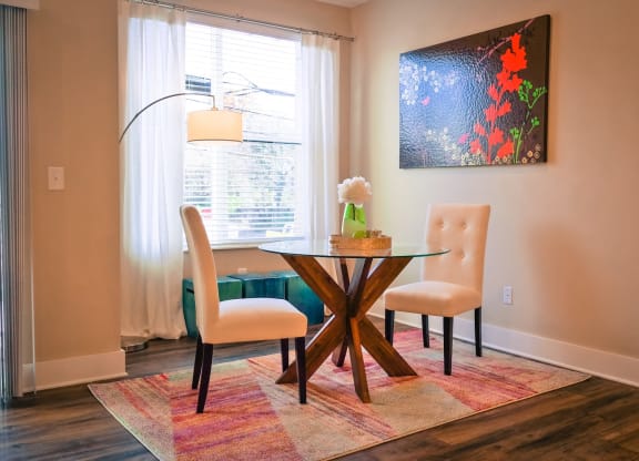 a dining room with a table and two chairs at DeSales Flats Apartments*, Cincinnati