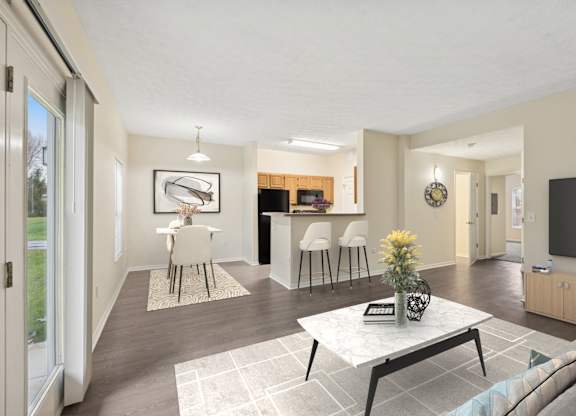 A modern living room with a white coffee table and a television.