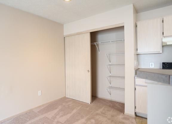 A kitchen area with a white fridge and a white wall.at Sharon Glen, Columbus