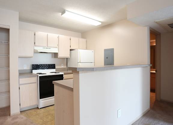 A kitchen with white cabinets and a stove top oven.at Sharon Glen, Columbus, 43229