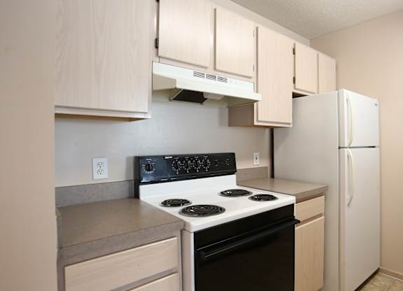 A kitchen with a stove, oven, and refrigerator.at Sharon Glen, Columbus Ohio