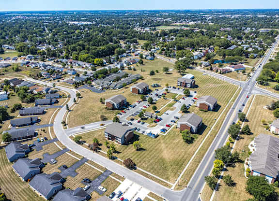 A suburban neighborhood with houses and a road.