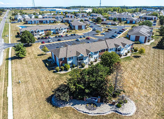 A bird's eye view of a residential area with houses and a sign in the foreground.