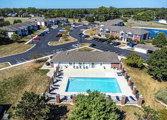 A bird's eye view of a residential complex with a swimming pool.