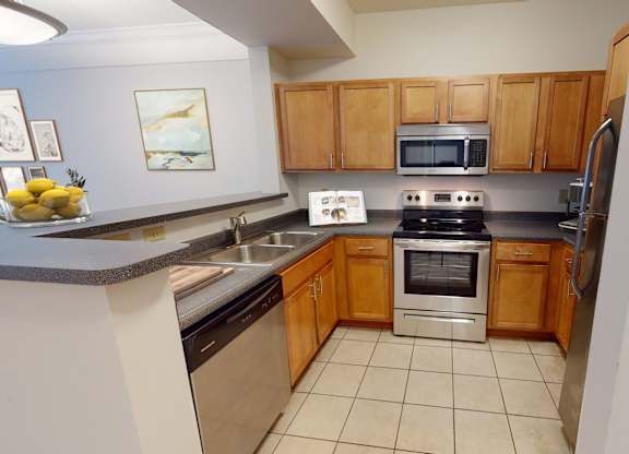 a kitchen with wooden cabinets and stainless steel appliances