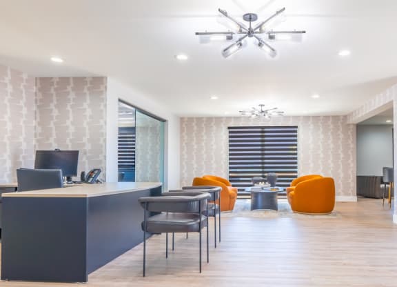 an office with a desk and chairs and a conference room