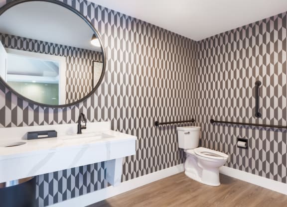 a bathroom with a toilet and a sink and a mirror