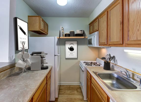 a kitchen with wood cabinets and white appliances