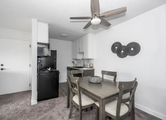 Dining room with a table and chairs and a ceiling fan at Tall Timber Apartments, 45241