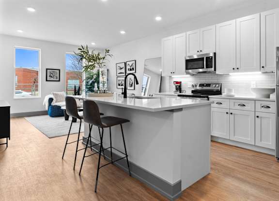 A kitchen with a white counter and a refrigerator.