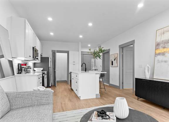 A modern kitchen with white cabinets and appliances.