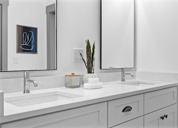 A bathroom with a white sink and a mirror.