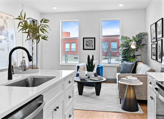 A modern kitchen with a large island and a dining area.