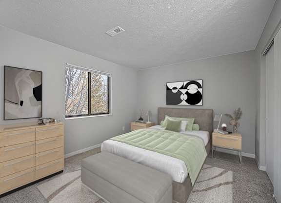 A bedroom with a bed, nightstand, and a painting on the wall at The Reserve at Grand Valley Apartments, Milford, 45150
