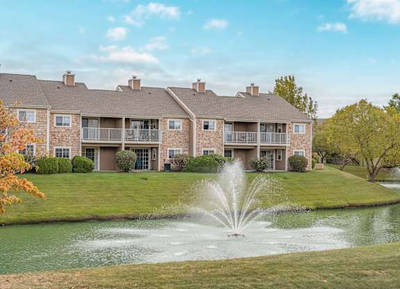 A large building with a fountain in front of it.