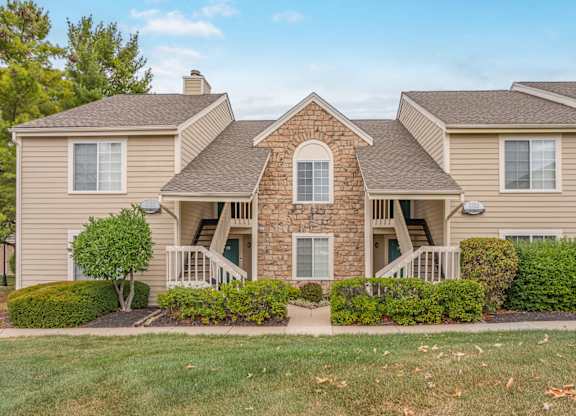 A house with a stone facade and a large front porch.