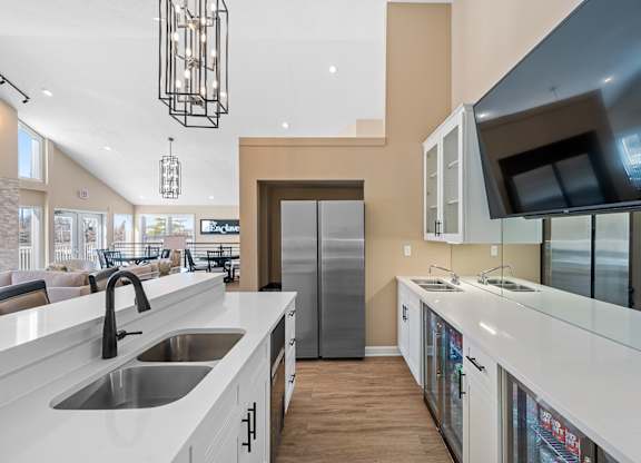 A modern kitchen with a white countertop and stainless steel appliances at Enclave, Beavercreek, Ohio